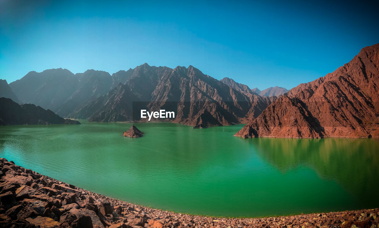 Scenic view of lake and mountains against sky