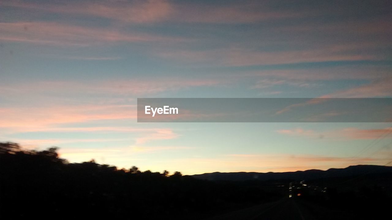 SCENIC VIEW OF LANDSCAPE AT SUNSET