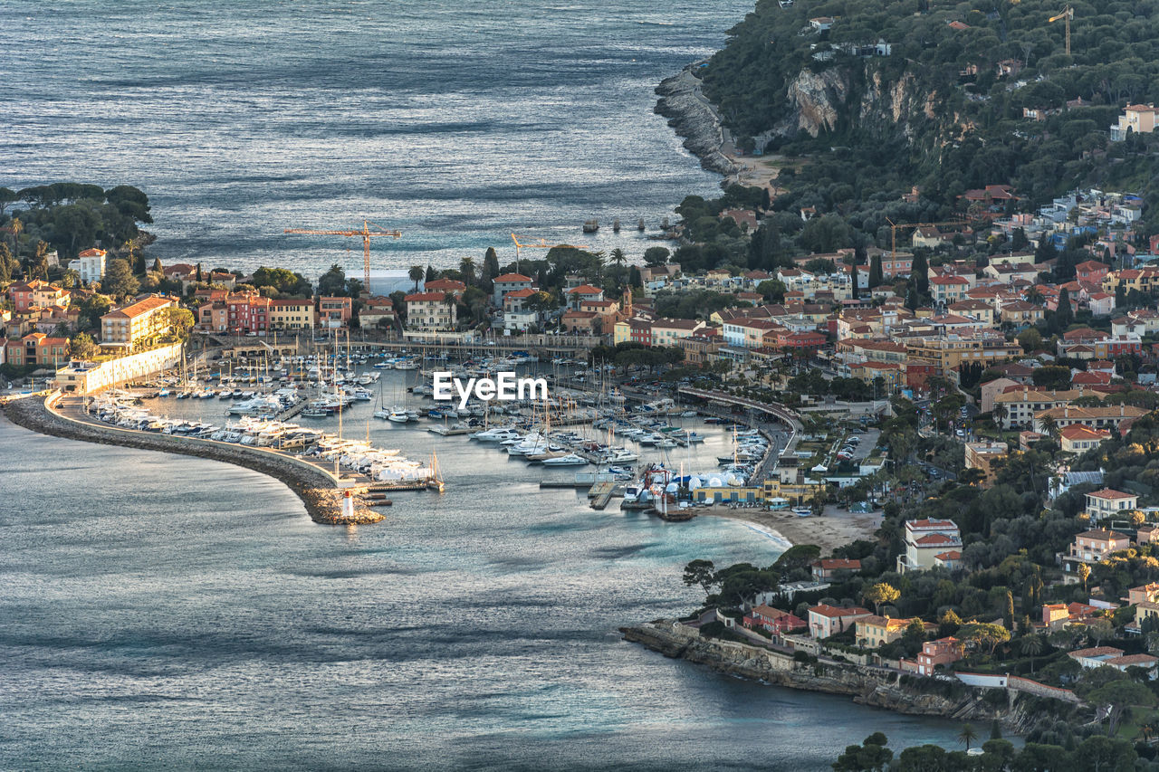 High angle view of sea and buildings in city