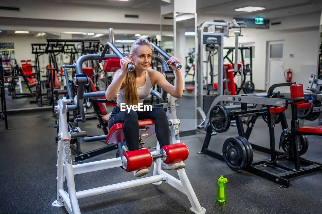 side view of woman exercising in gym