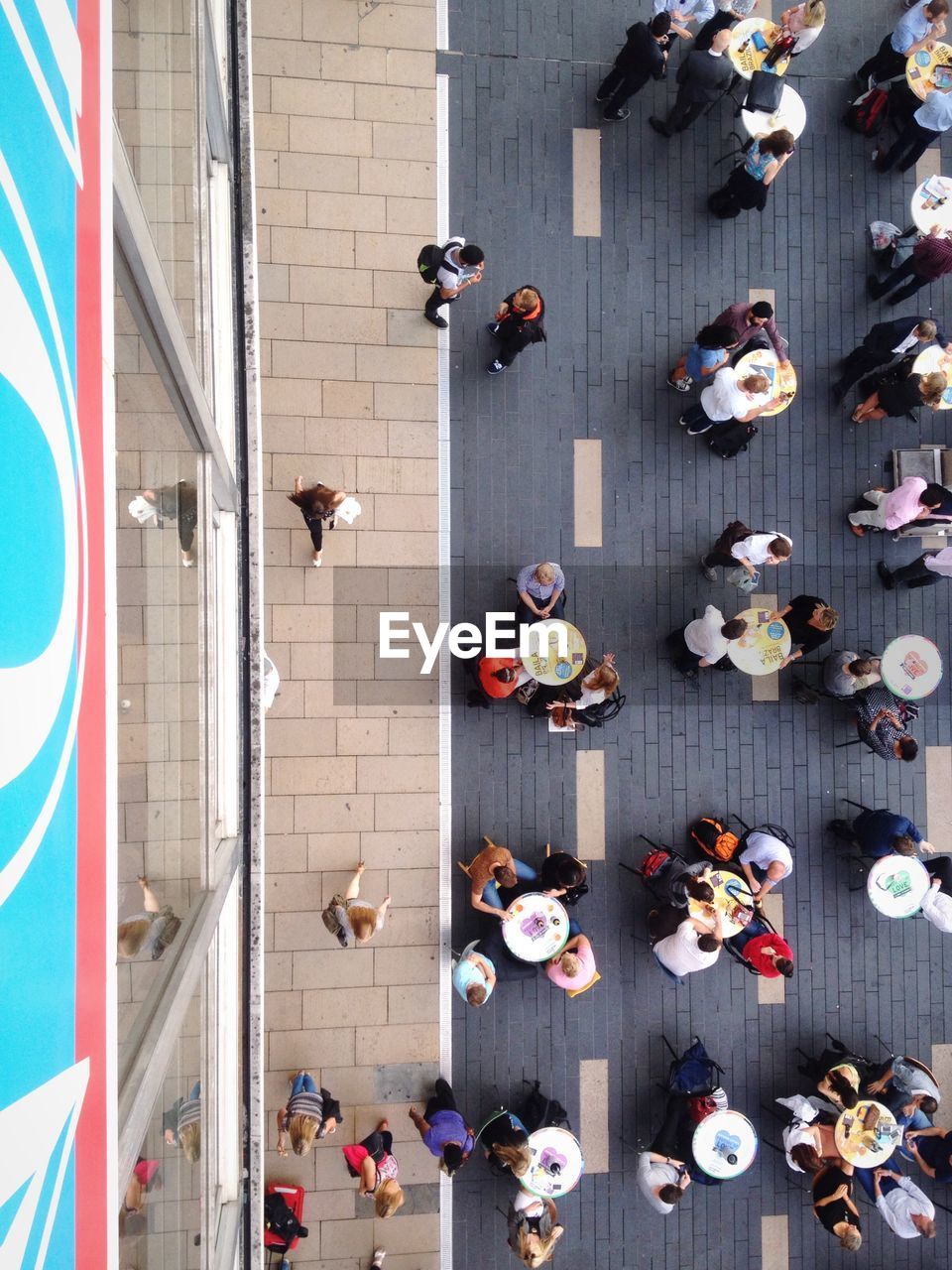 Directly above shot of people at sidewalk cafe in city