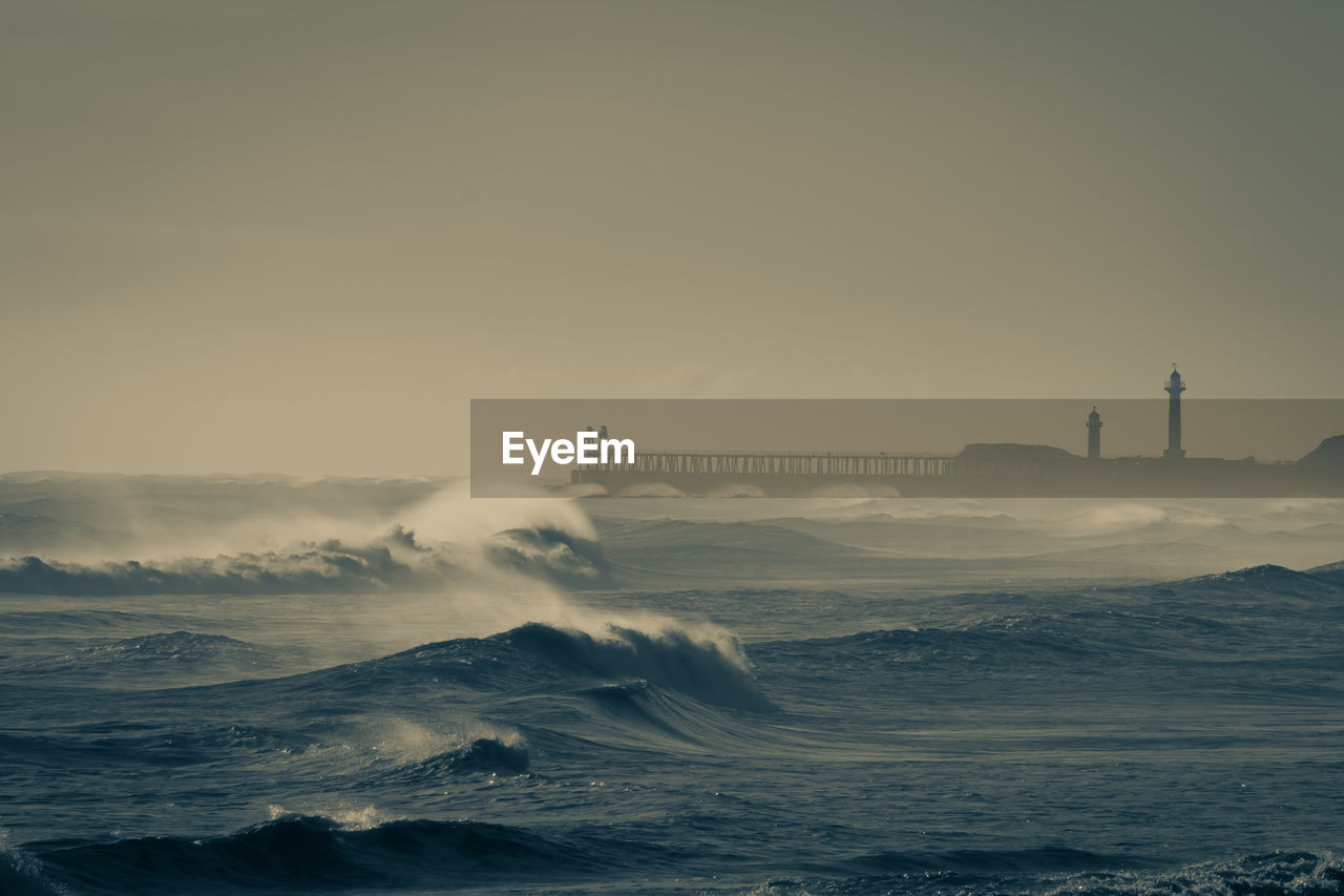 Scenic view of sea against sky during sunset whitby rough seas