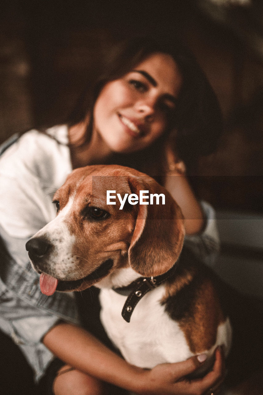 Portrait of dog and woman at home