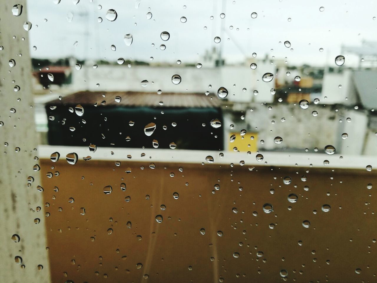 CLOSE-UP OF WET WINDOW IN RAINY SEASON