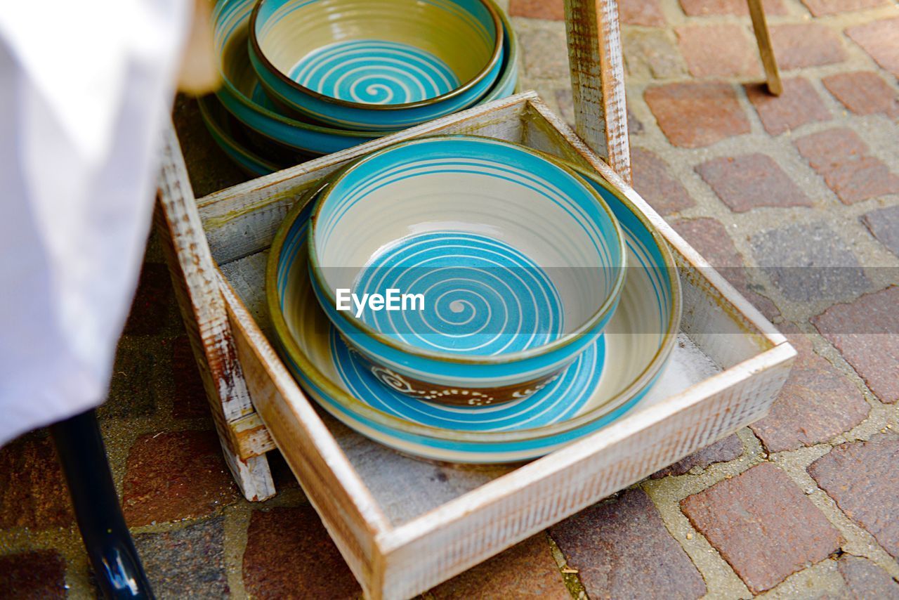 High angle view of ceramics in tray on footpath