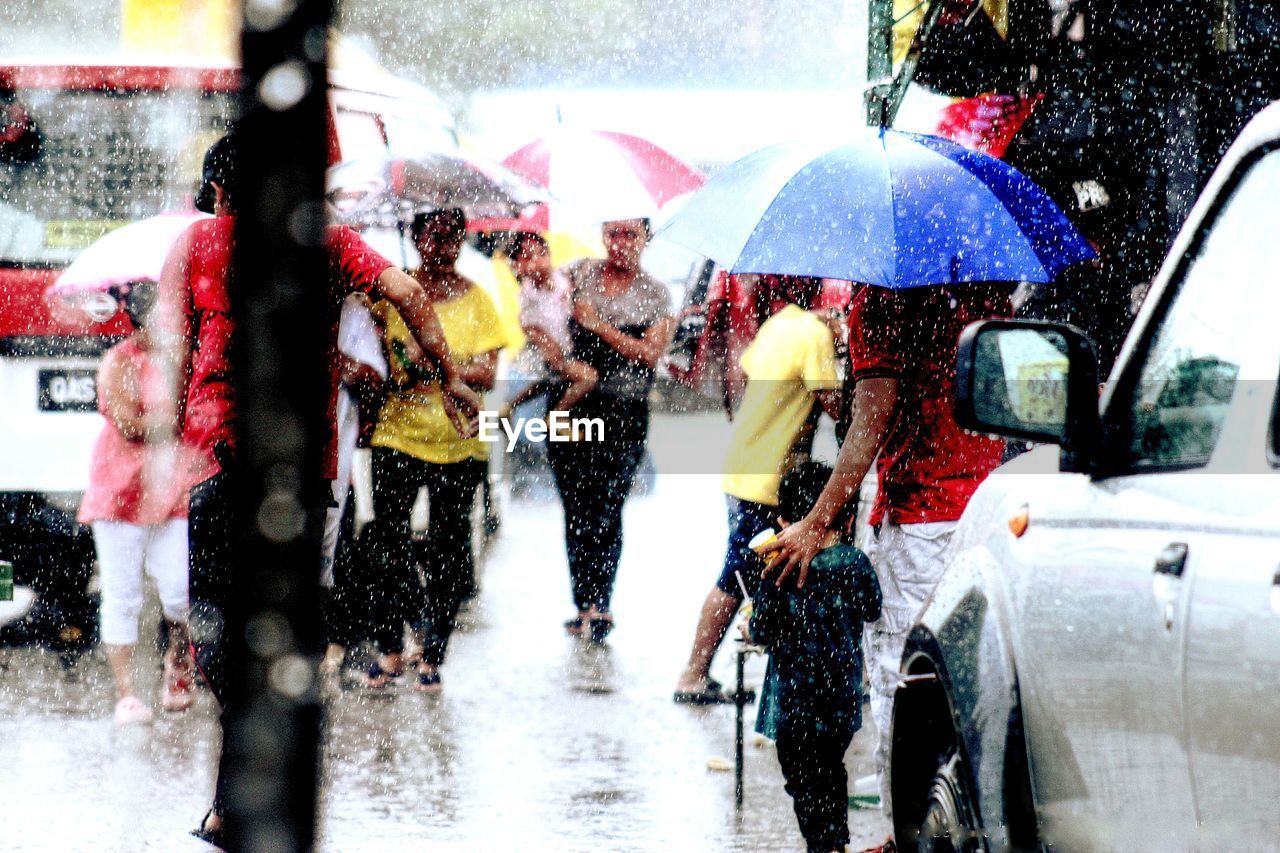 People on wet road during rainy season