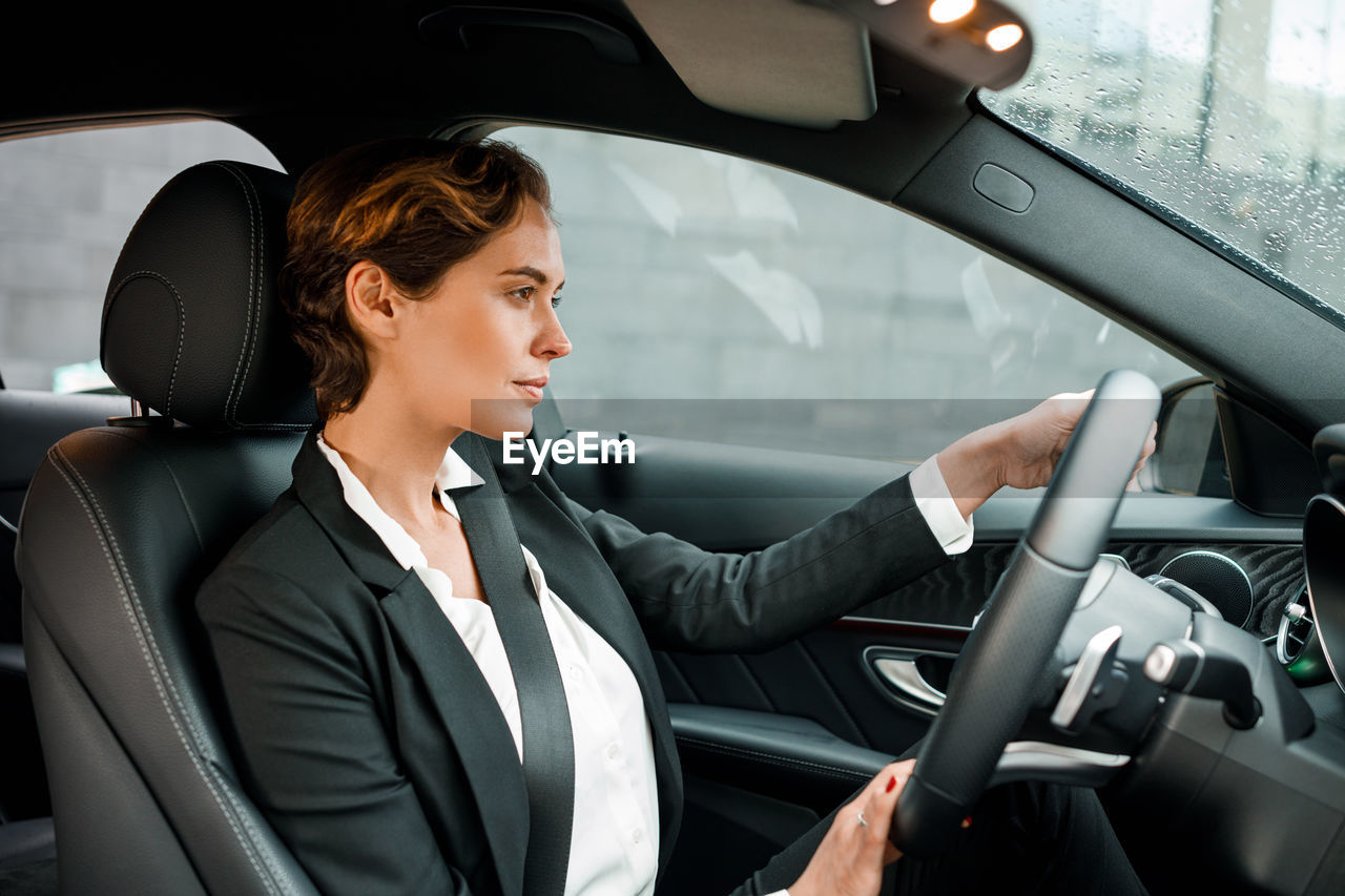 Businesswoman driving car