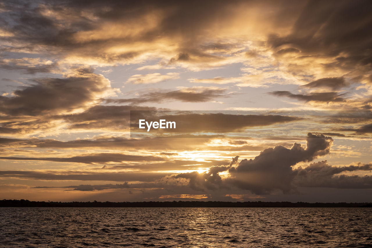 Beautiful amazon sunset clouds over the waters of negro river