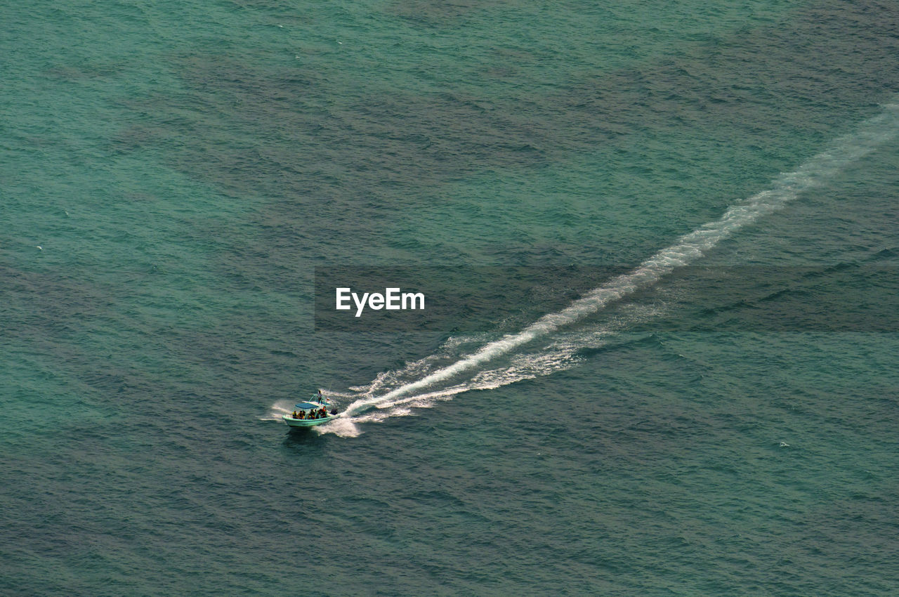 HIGH ANGLE VIEW OF NAUTICAL VESSEL IN SEA