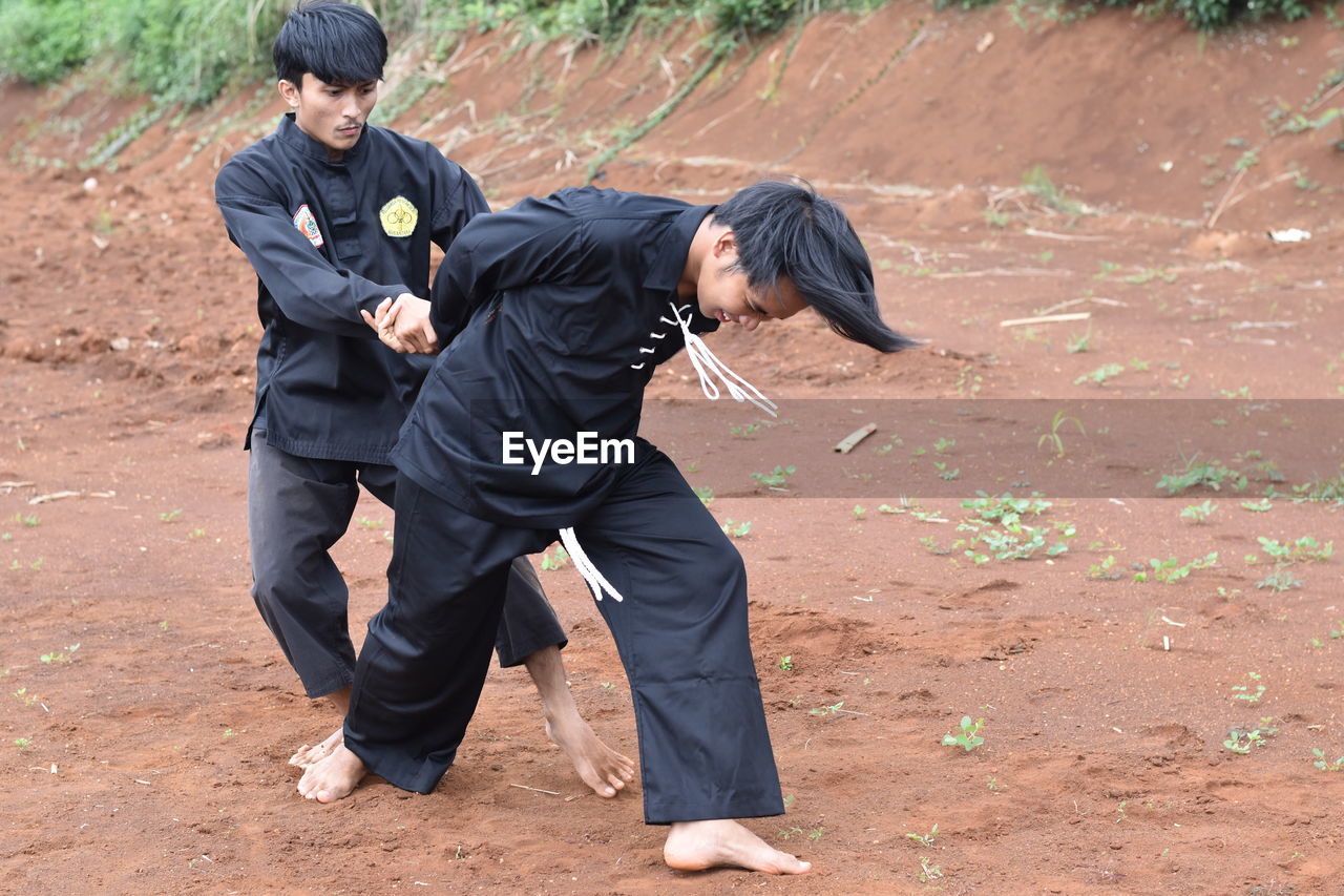 Young men practicing karate outdoors