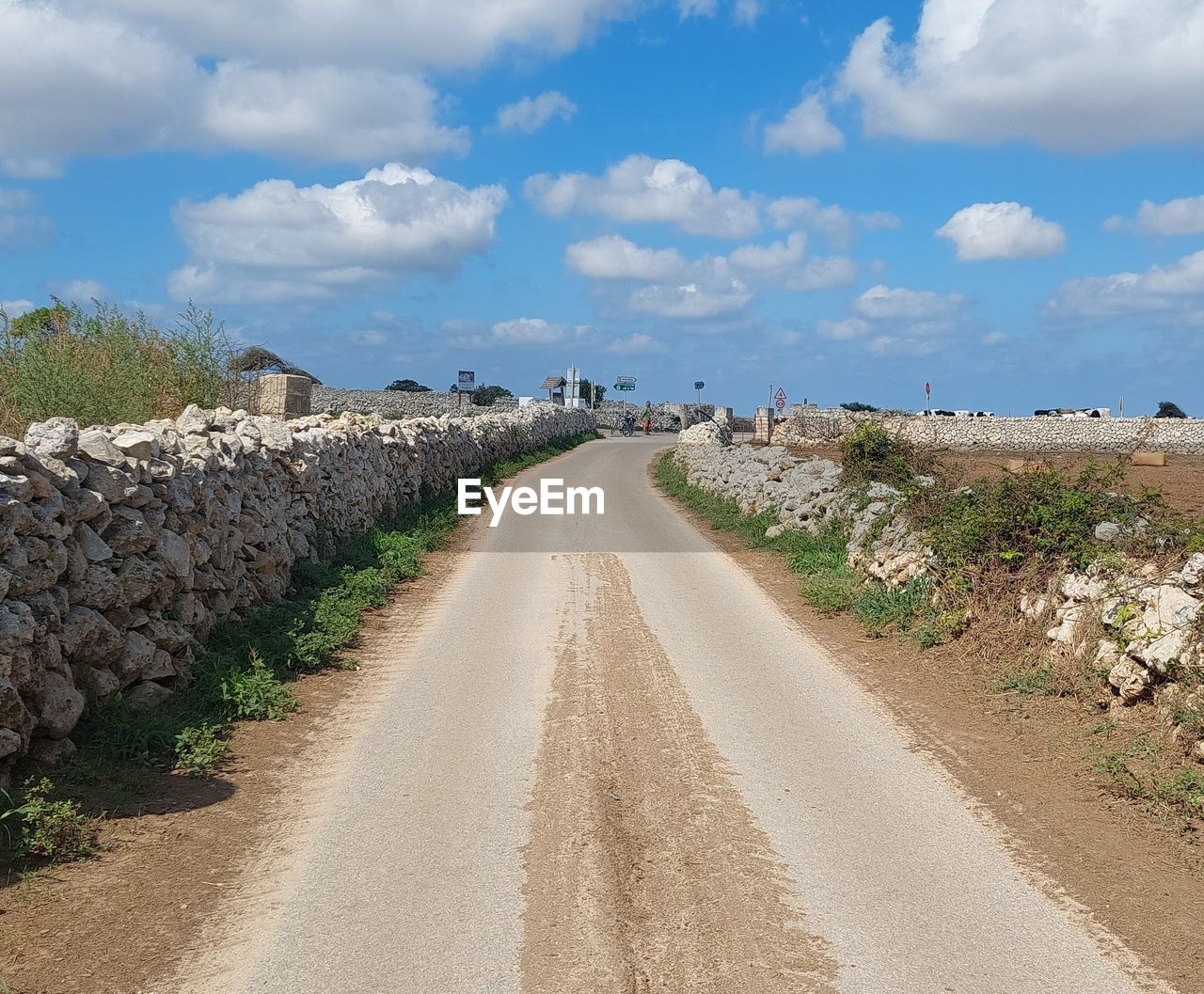 sky, cloud, road, nature, landscape, land, environment, the way forward, transportation, sea, coast, scenics - nature, travel, rural area, diminishing perspective, no people, vanishing point, travel destinations, plant, soil, outdoors, blue, day, dirt road, dirt, beauty in nature, water, city, tourism, sand, footpath, tranquility, infrastructure, architecture, street, walkway, horizon, tranquil scene