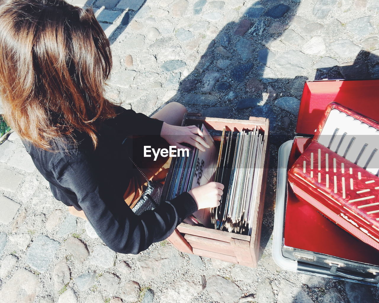 High angle view of woman choosing vinyl records at market