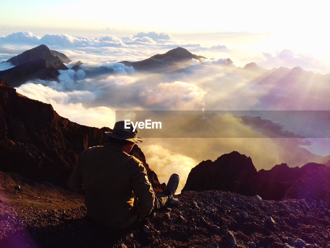 Man looking at mountains against sky