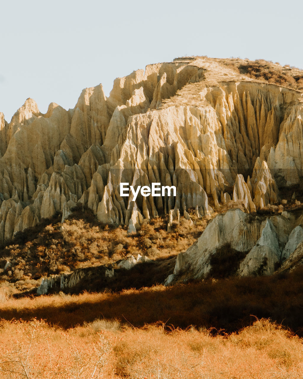 Rock formations on landscape against clear sky