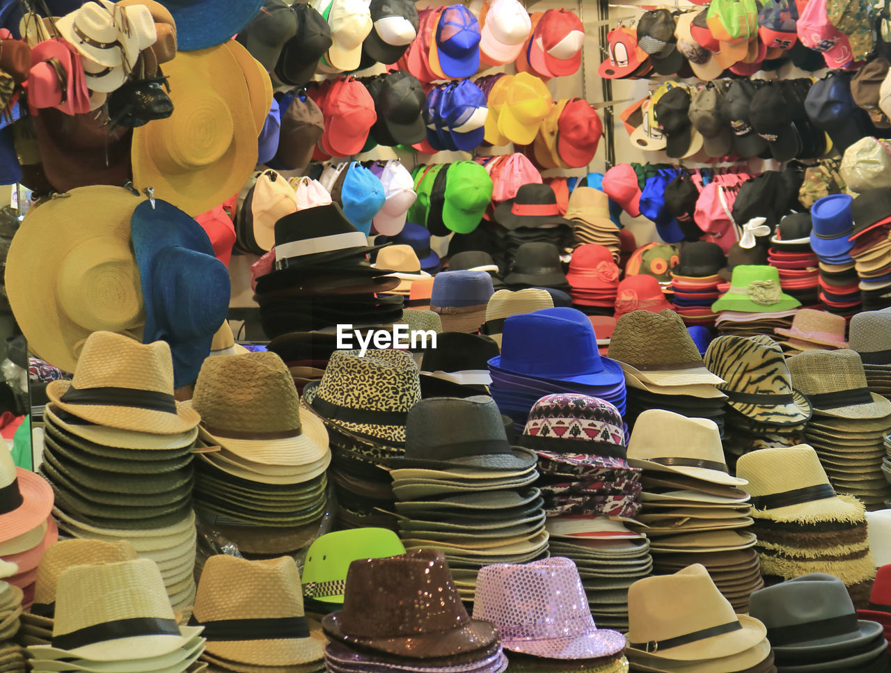 Multi colored hats for sale at market stall