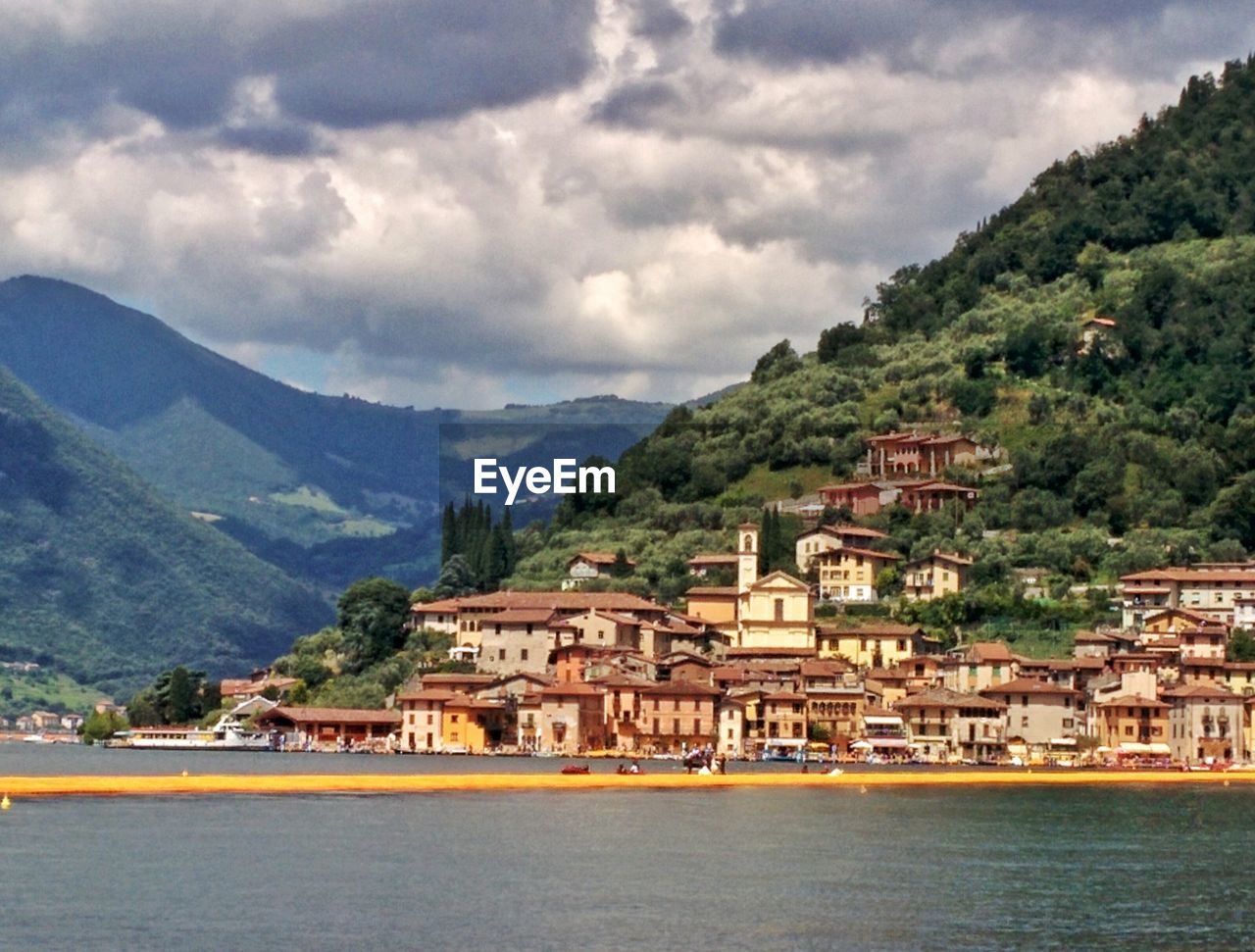 VIEW OF TOWNSCAPE WITH MOUNTAIN RANGE IN BACKGROUND