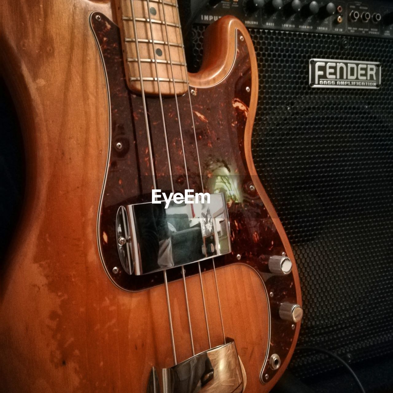 CLOSE-UP OF GUITAR IN THE MIRROR