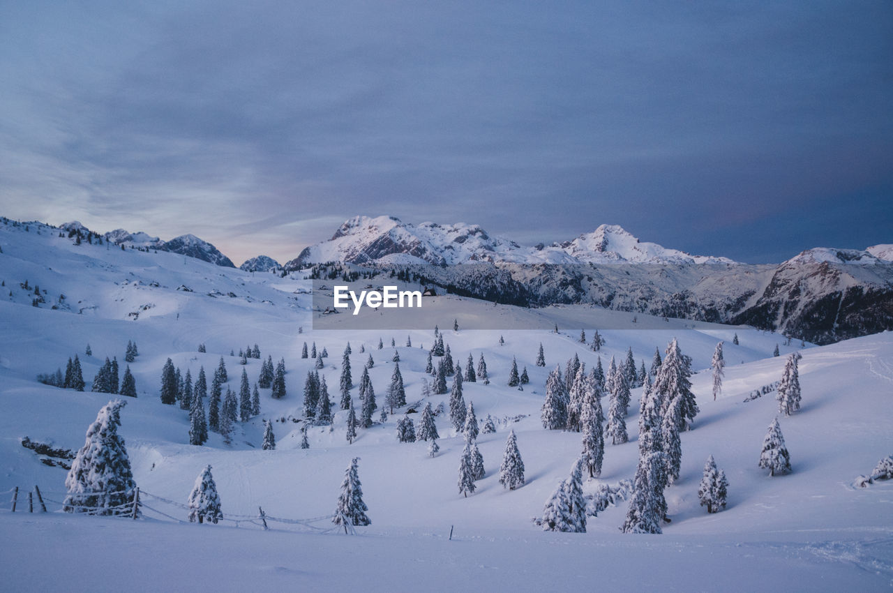 Scenic view of snow covered mountains against sky