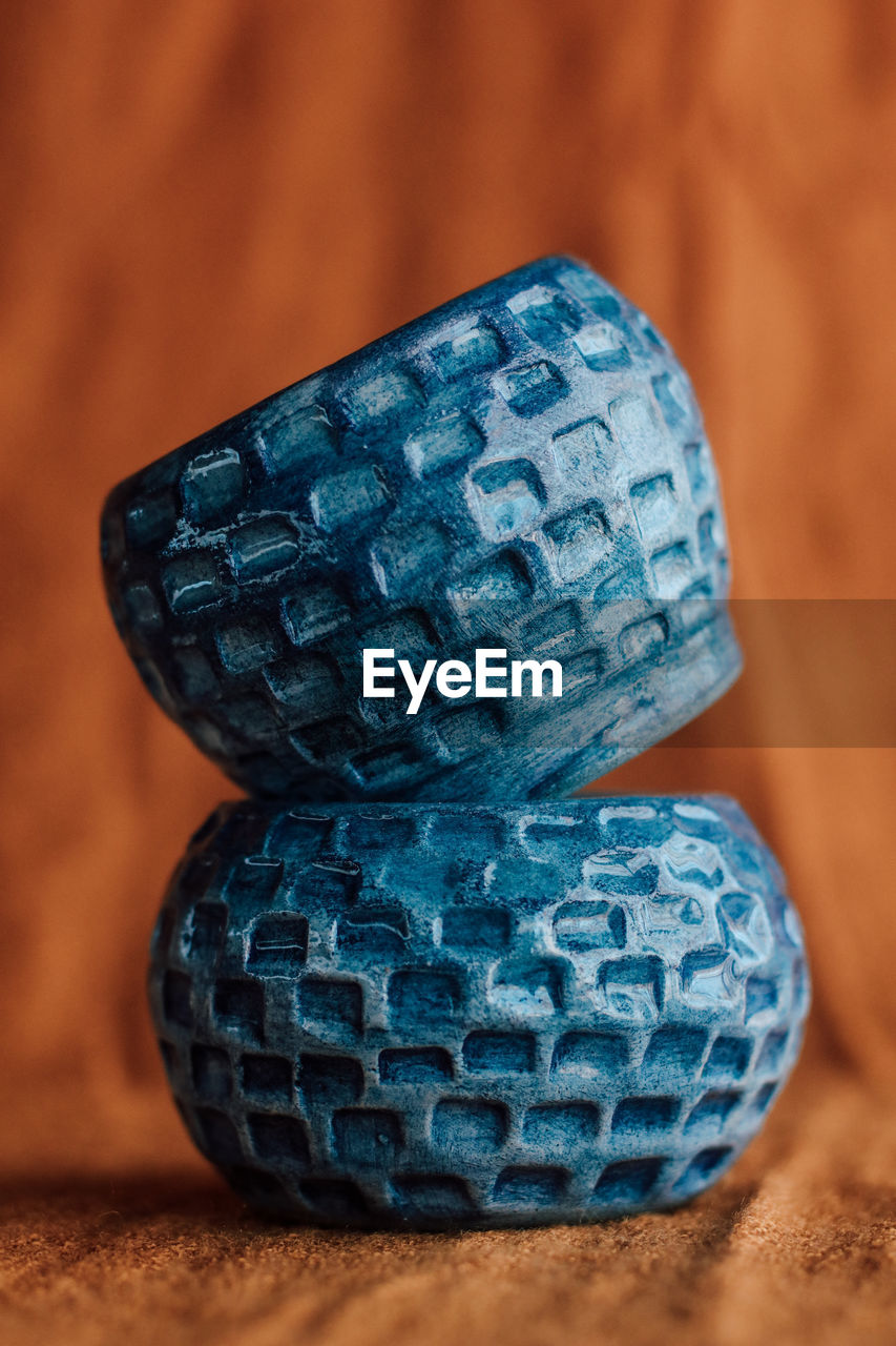 CLOSE-UP OF BLUE STONE ON TABLE WITH PEBBLES