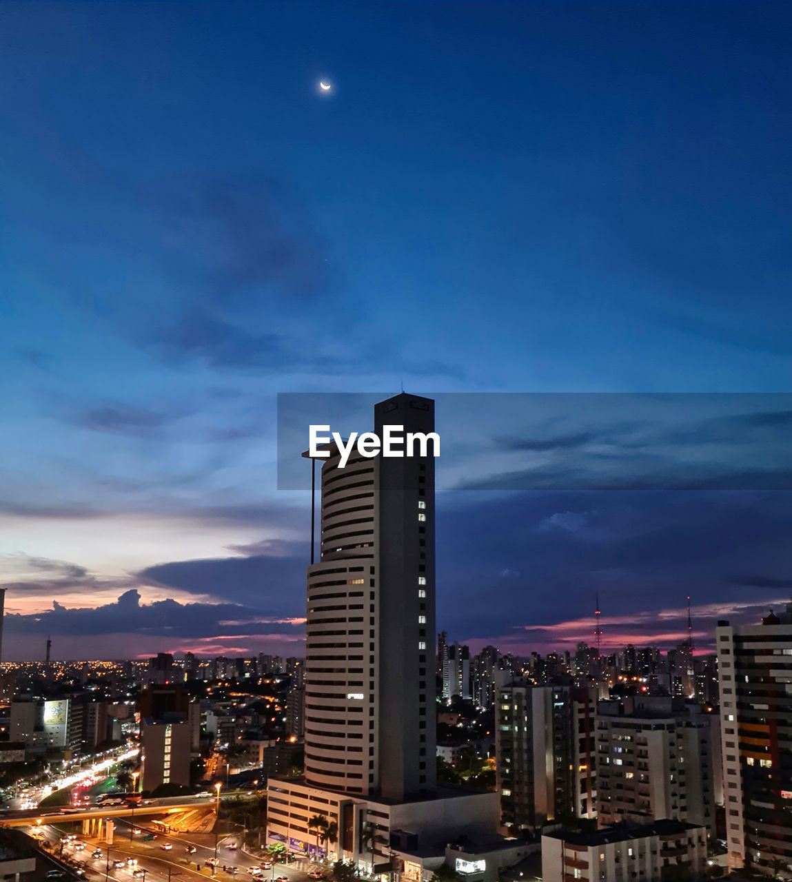 ILLUMINATED BUILDINGS AGAINST SKY AT NIGHT