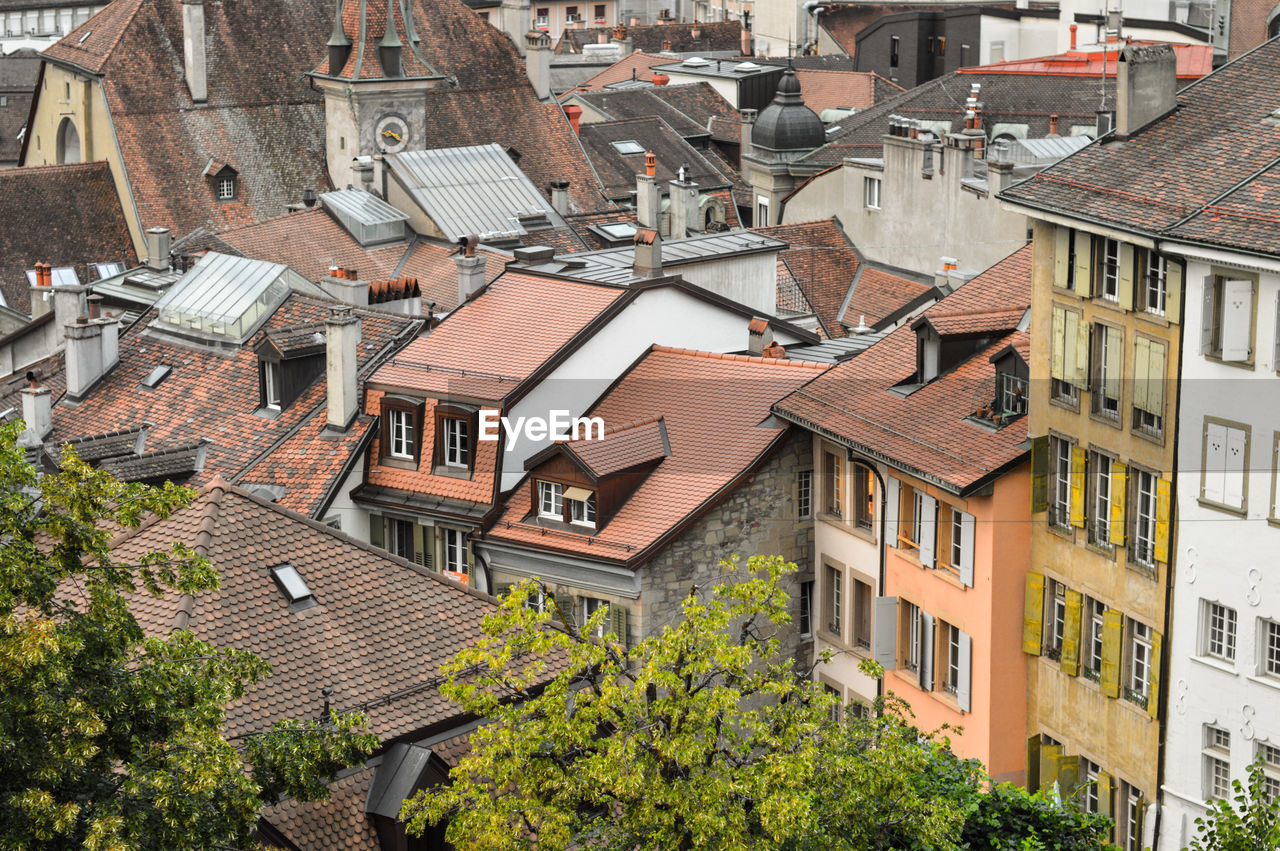 HIGH ANGLE VIEW OF STREET AMIDST BUILDINGS