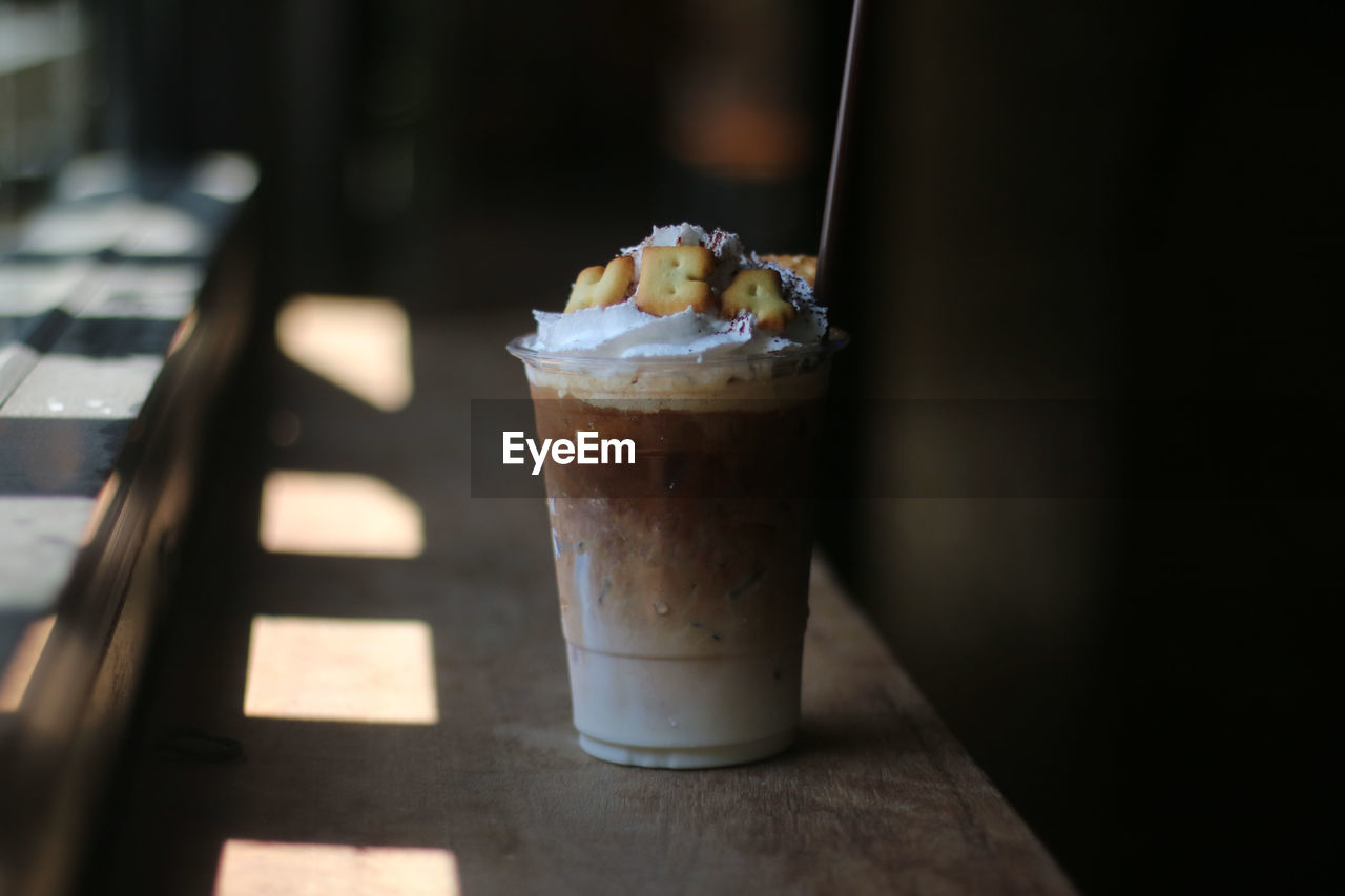 CLOSE-UP OF ICE CREAM WITH GLASS OF TABLE