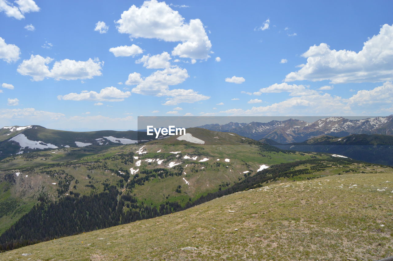 environment, landscape, scenics - nature, sky, mountain, beauty in nature, mountain range, cloud, nature, land, meadow, ridge, tranquility, grass, tranquil scene, plant, travel, travel destinations, no people, non-urban scene, mountain pass, highland, plateau, blue, tourism, snow, day, idyllic, outdoors, rural scene, cold temperature, valley, summer, grassland, field, plain, winter, green, sunlight, tree, architecture, vacation, trip, social issues, remote, building, wilderness, activity