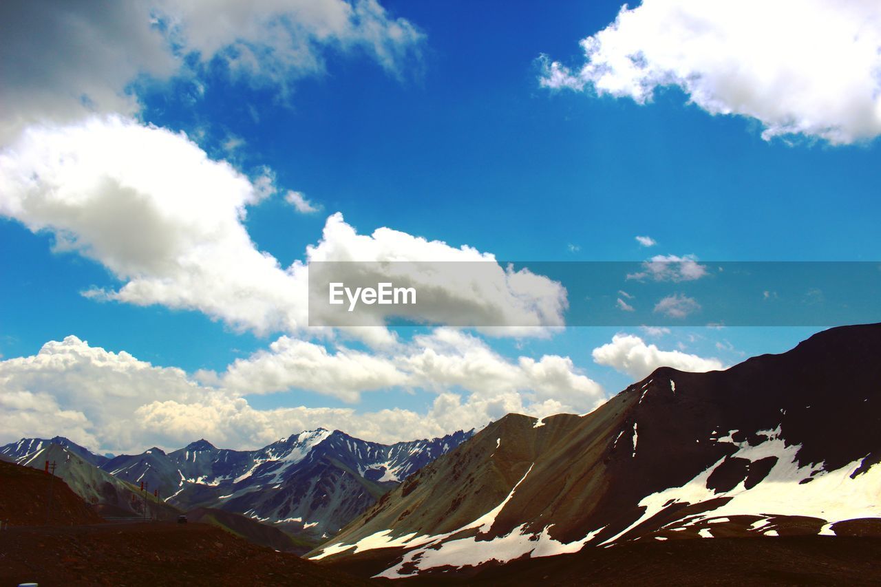 View of mountain range against cloudy sky