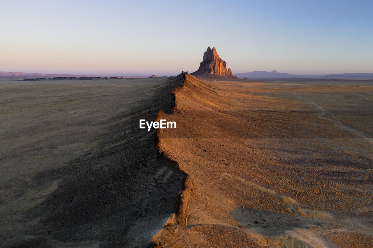 Aerial with leading line of lava towards shiprock in new mexico