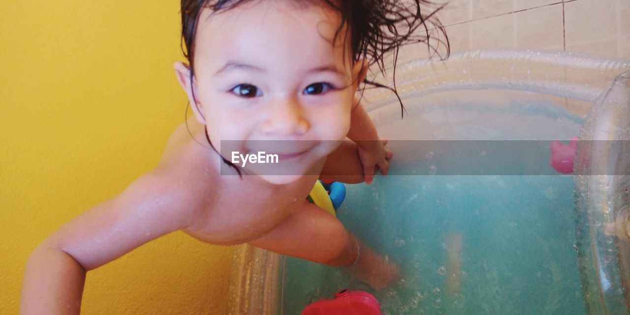 PORTRAIT OF SHIRTLESS BOY IN WATER