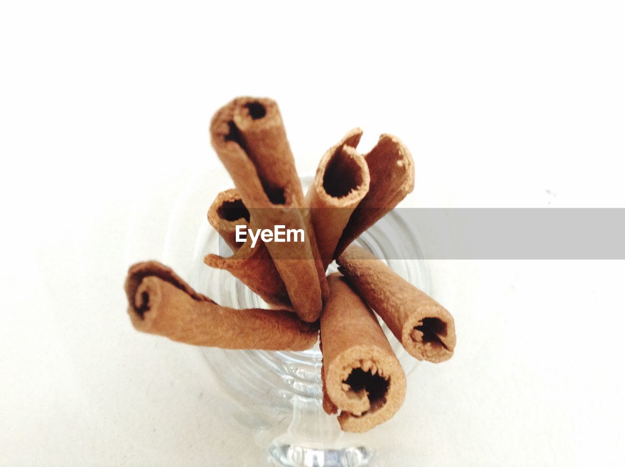 Close-up of cinnamon sticks in jar on table