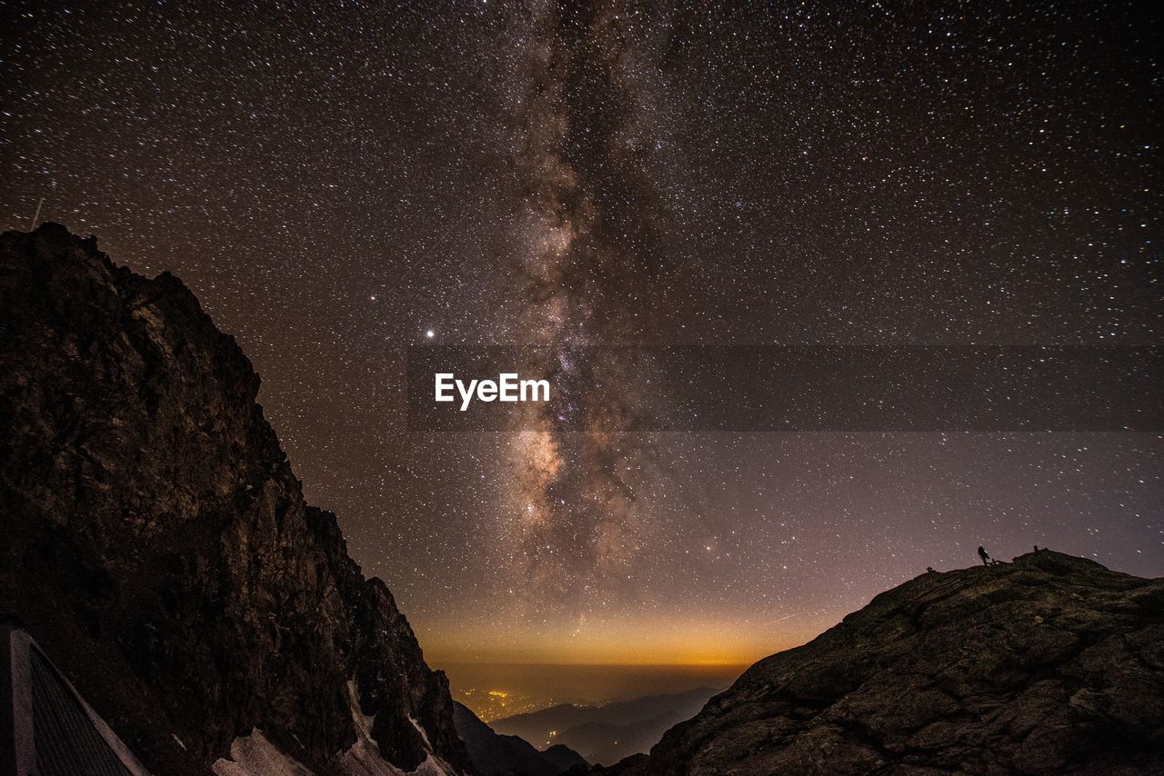 Scenic view of mountains against sky at night