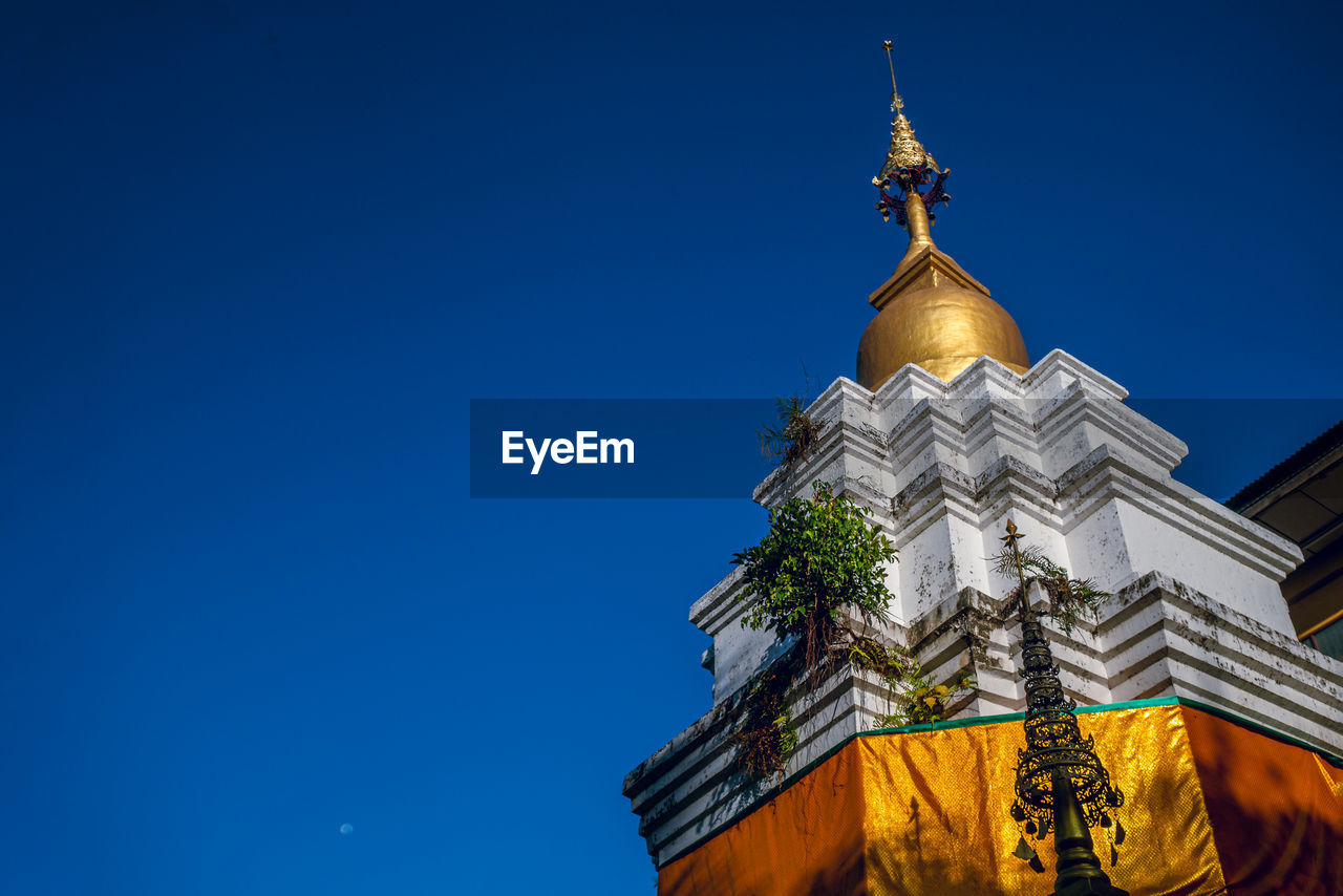 Low angle view of traditional building against clear blue sky