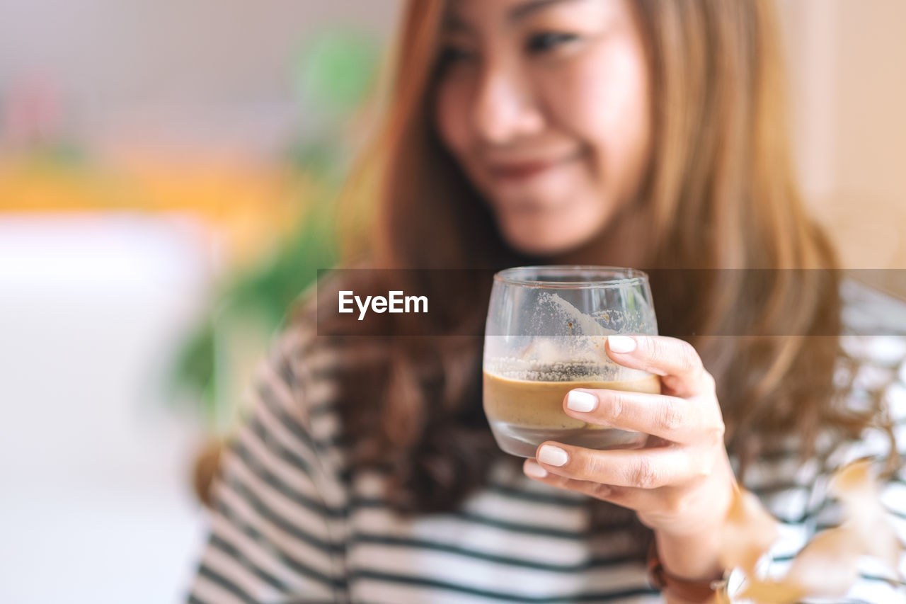 Mid adult woman having coffee at cafe