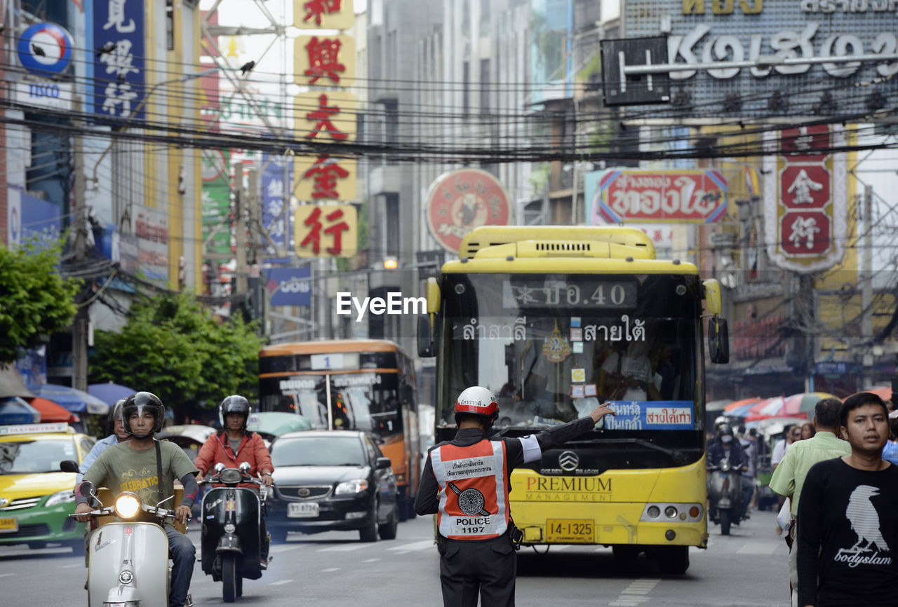 People and vehicle on road in city