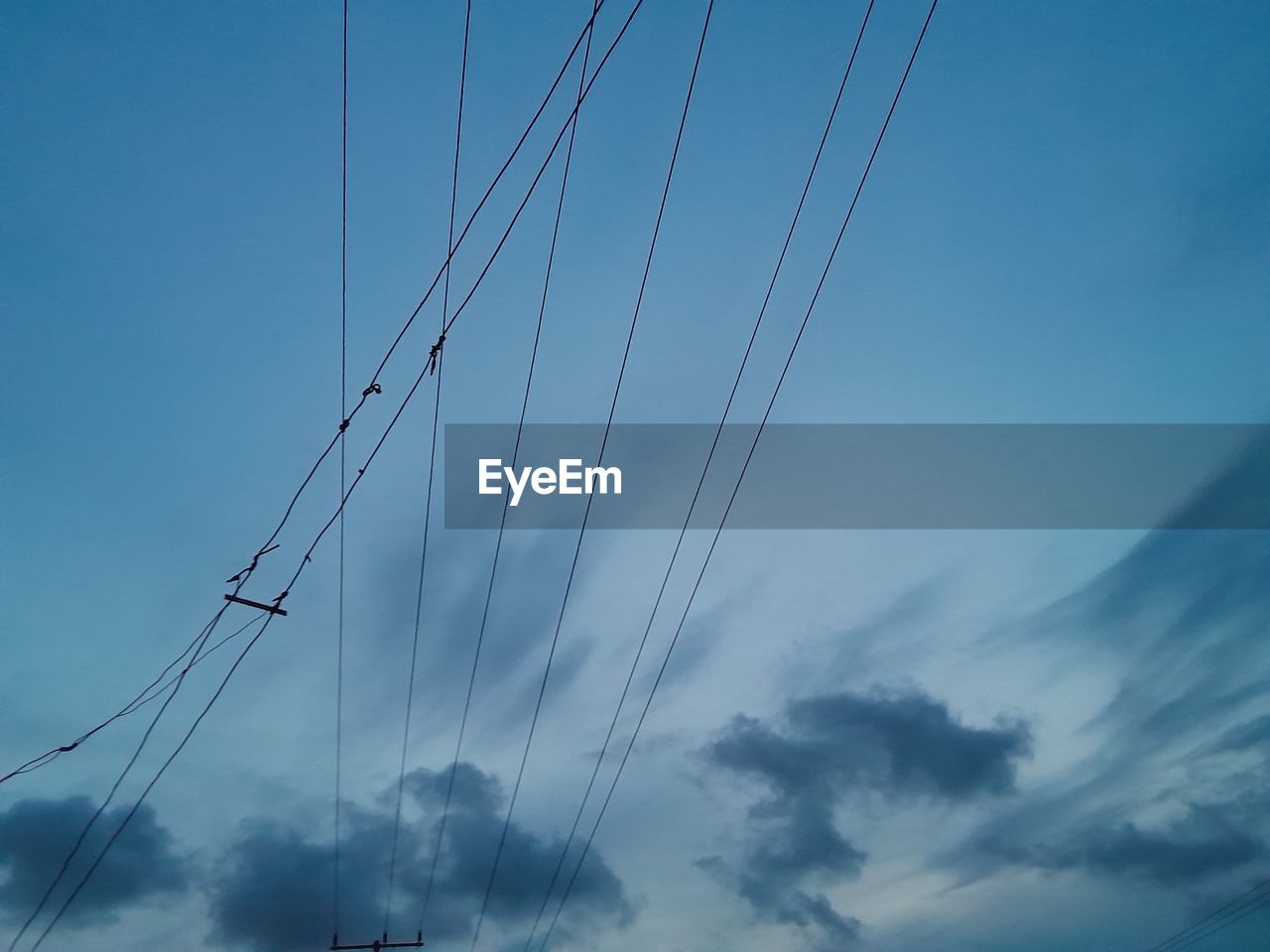 sky, blue, cloud, cable, line, nature, electricity, no people, low angle view, technology, transportation, outdoors, day, overhead power line, power line, power supply, power generation, mast, wind, mode of transportation, electrical supply