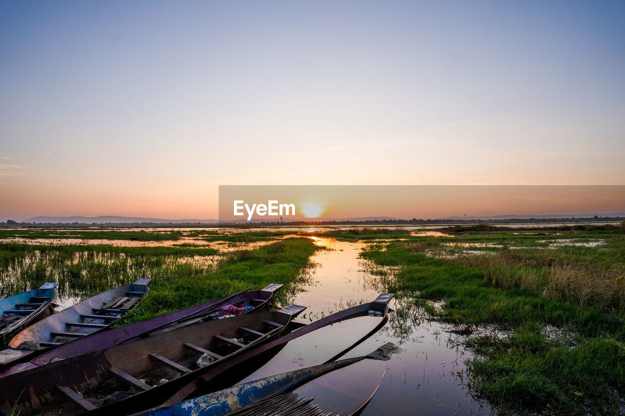 SCENIC VIEW OF SUNSET OVER CANAL