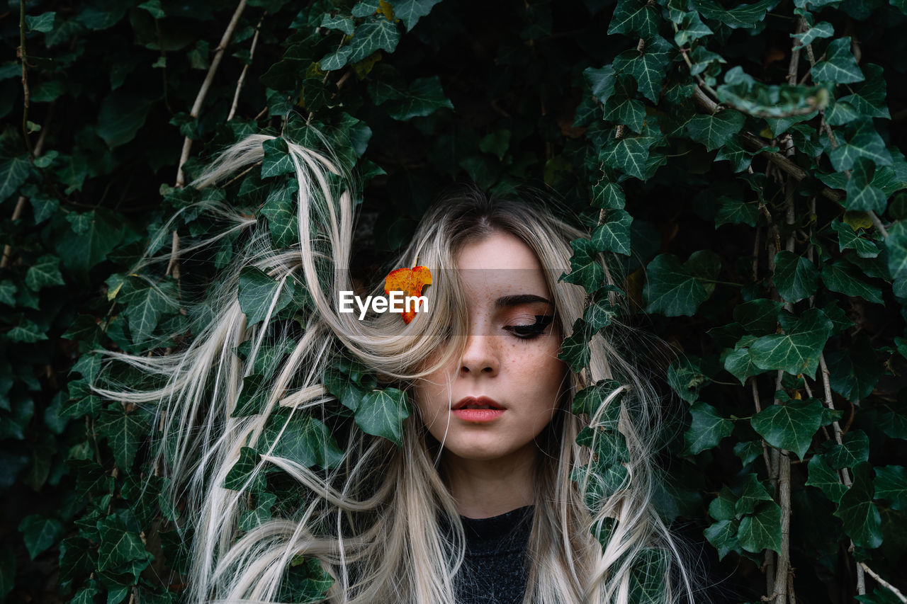 Close-up of beautiful young woman in forest