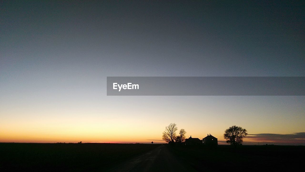 SCENIC VIEW OF SILHOUETTE TREES AGAINST SKY AT SUNSET