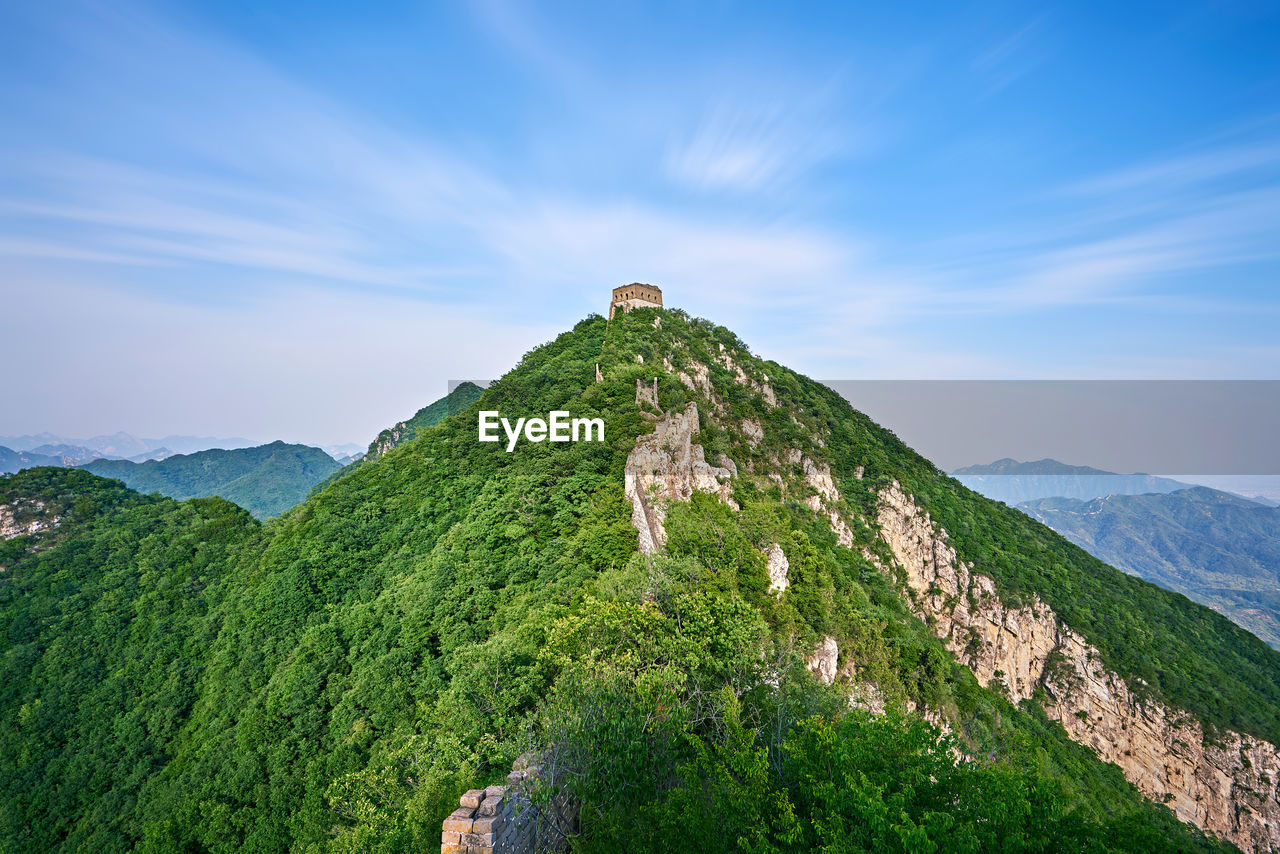 Scenic view of great wall of china on mountains against sky