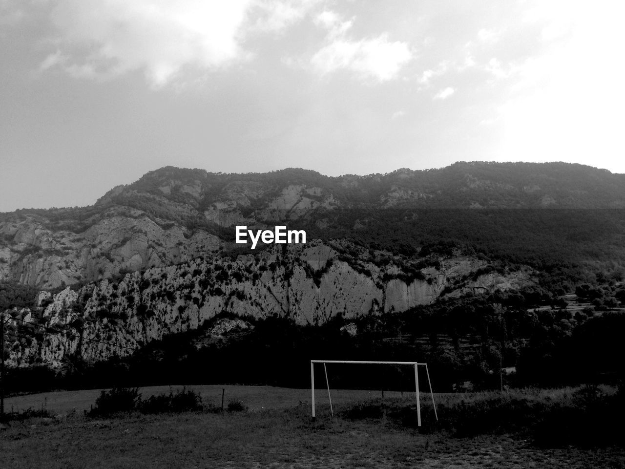 Landscape against rocky mountain range