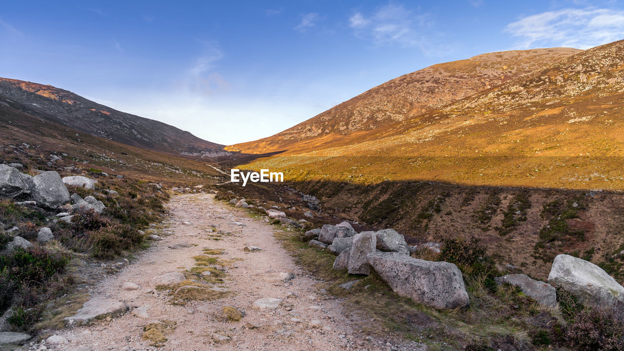 SCENIC VIEW OF MOUNTAIN BY ROAD AGAINST SKY