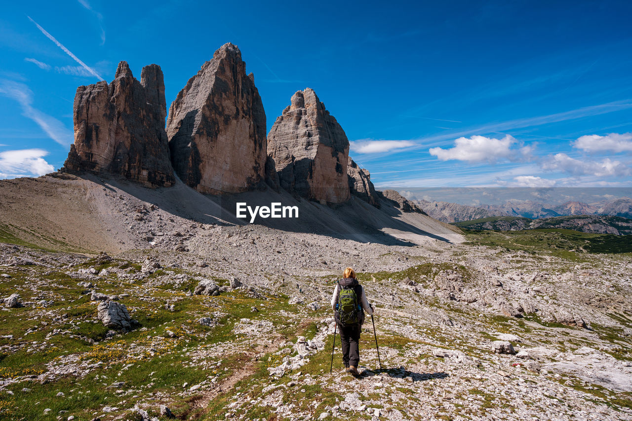 Rear view of woman hiking on land