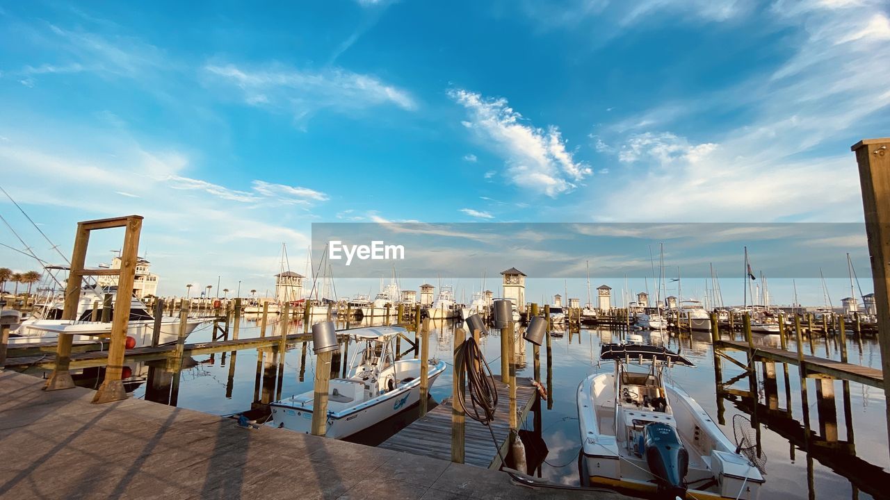 BOATS MOORED AT HARBOR