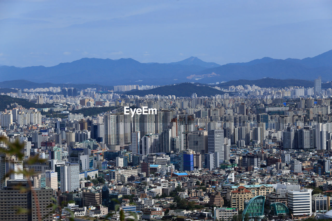 High angle view of modern buildings in city against sky