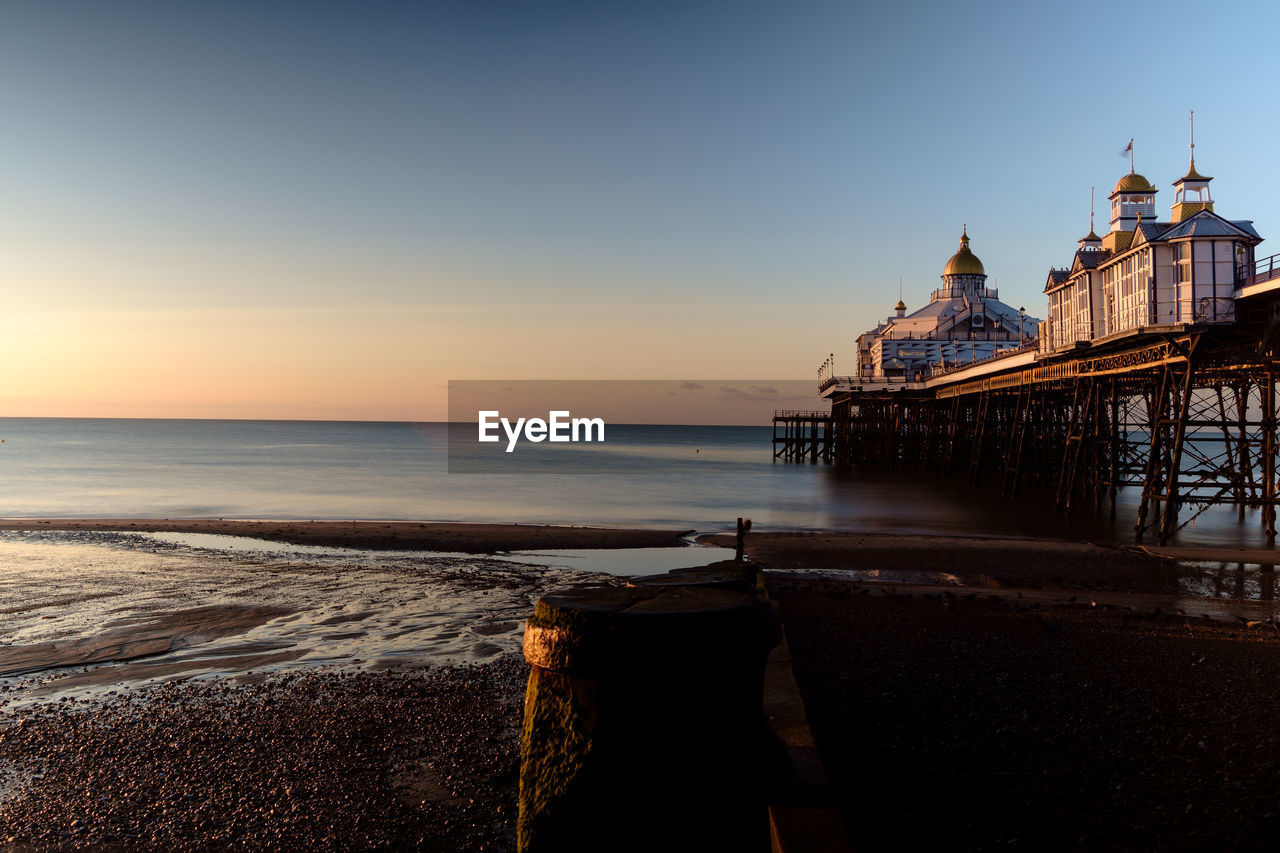 SCENIC VIEW OF BEACH AT SUNSET