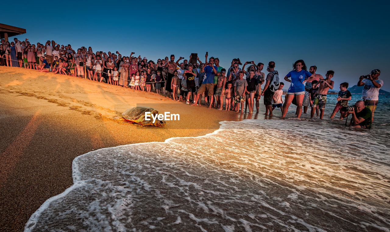 GROUP OF PEOPLE ON BEACH