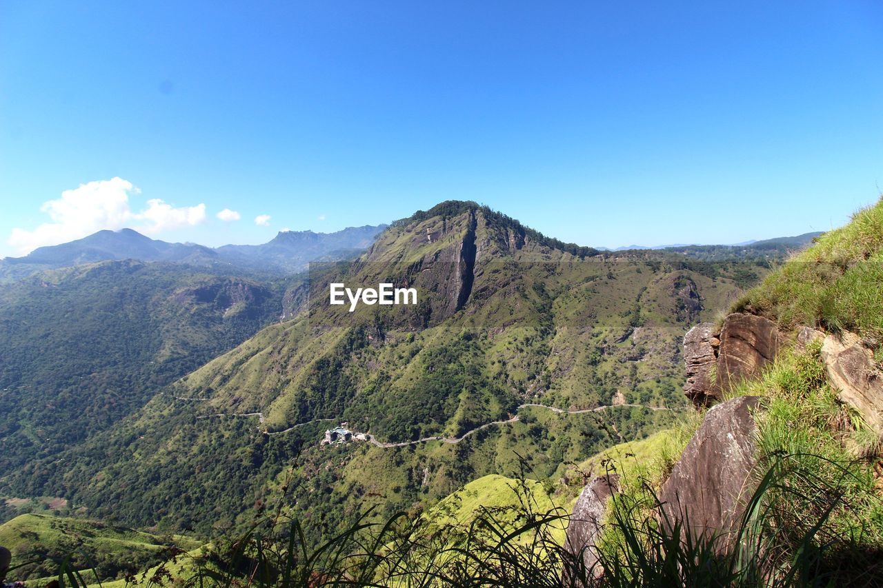 Scenic view of mountains against blue sky