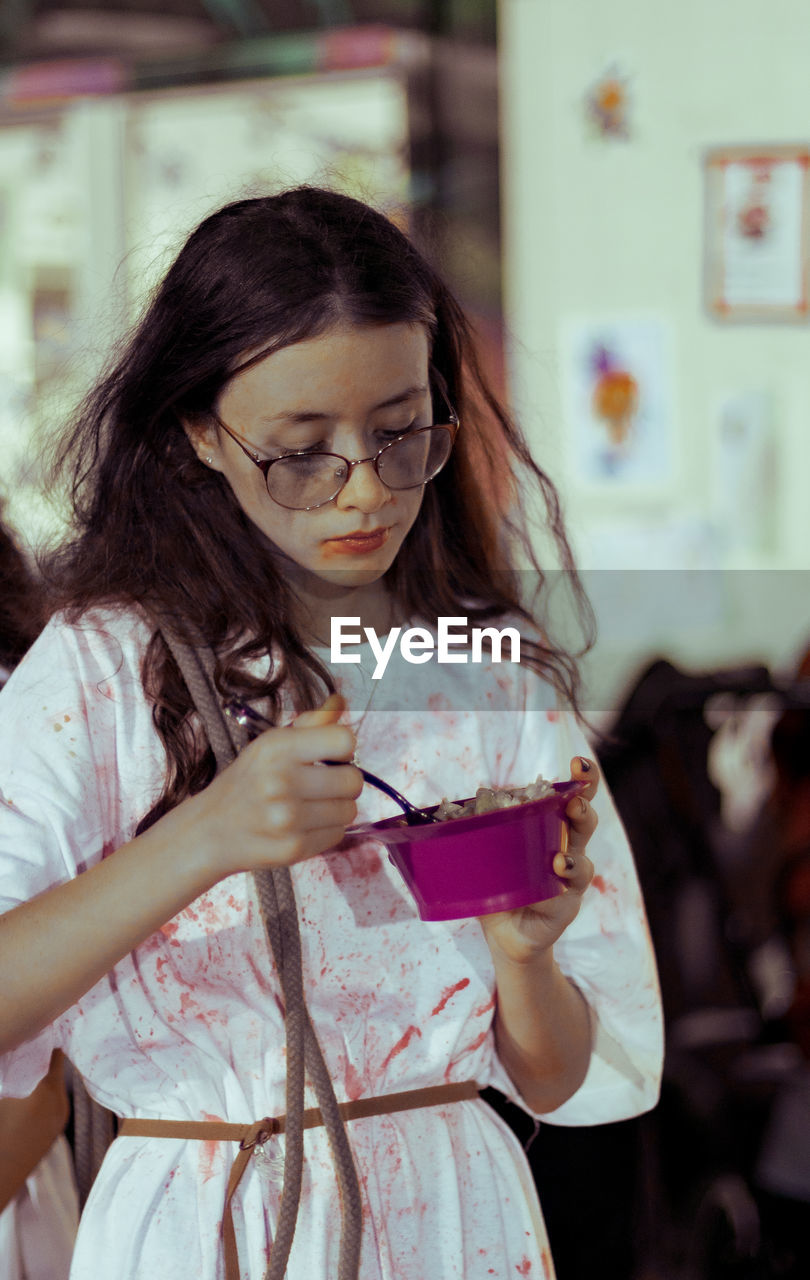 Portrait of a girl in a halloween costume with food.