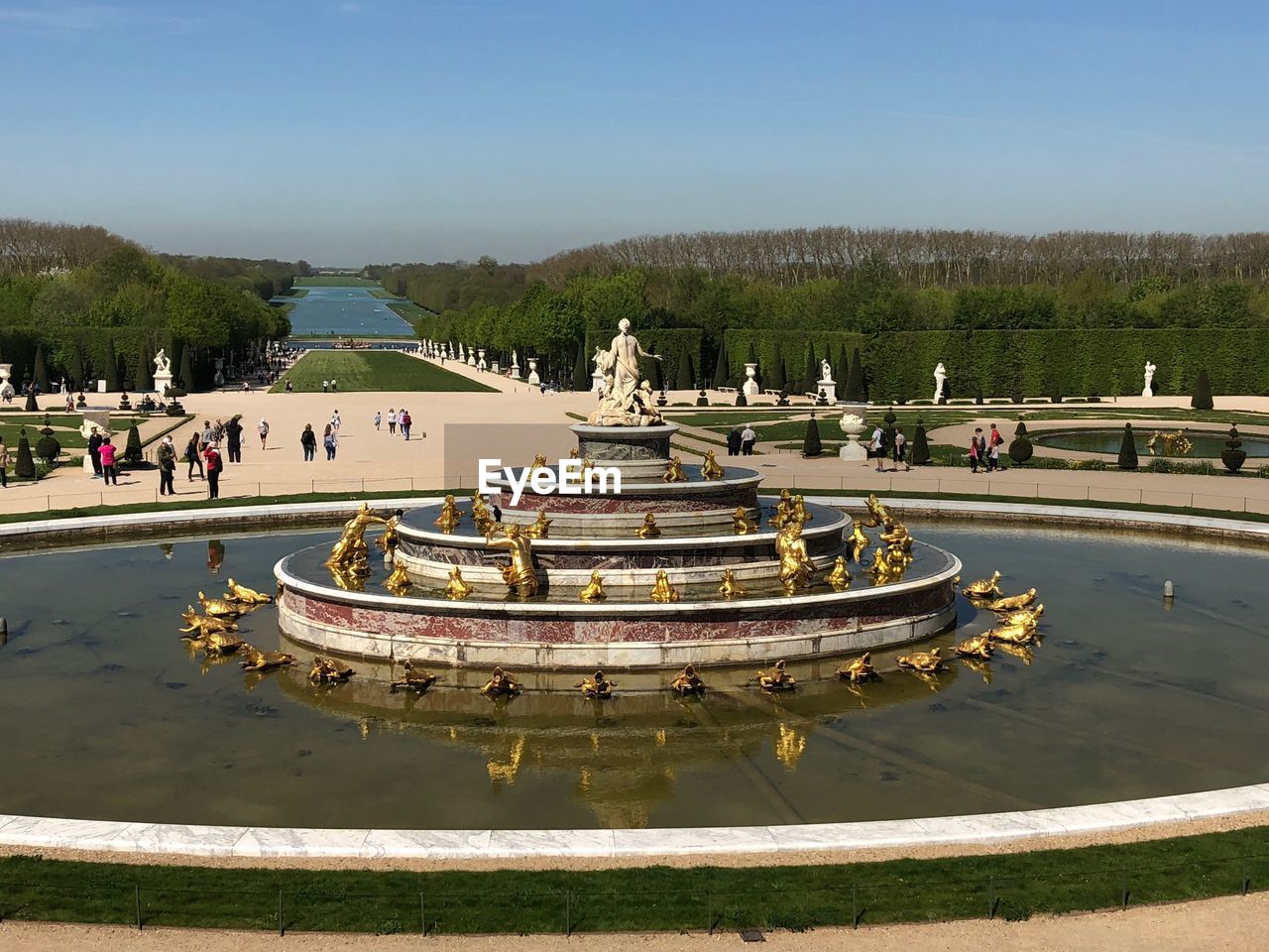 Statues in water fountain against sky